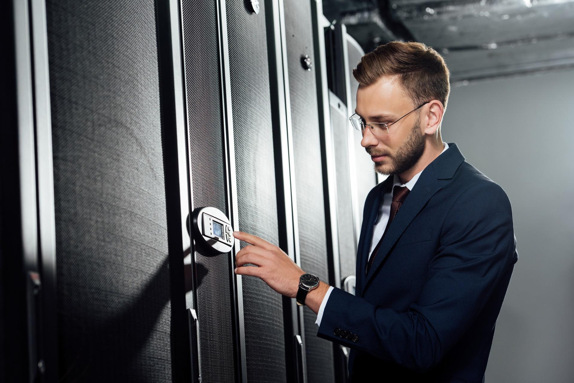 An engineer entering a code to open a server rack